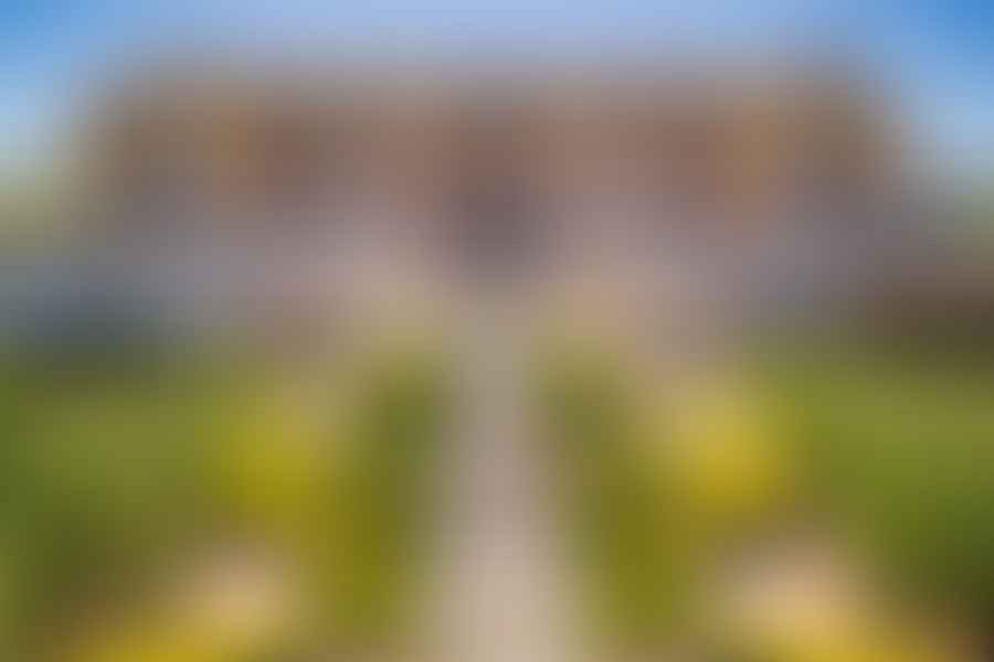 Scenic view of a winery in Napa Valley with vineyards and mountains in the background